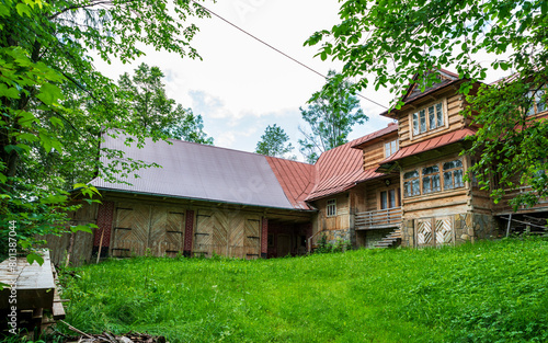 In the small village of Poronin in Poland lies this old farm house. The main wooden building is beautiful and surrounded by green grass and trees.