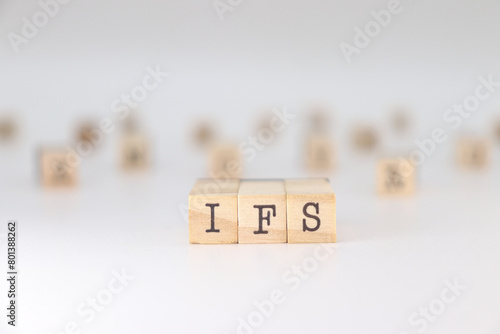 IFS acronym. Concept of Internal Family Systems written on wooden cubes isolated on white background photo
