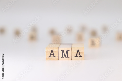 AMA word. Concept of ask me anything written on wooden cubes isolated on white background.