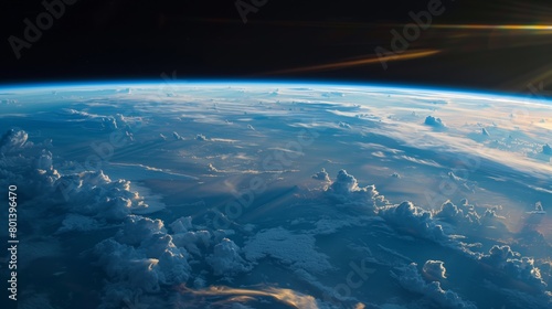 Stunning view of Earth's atmosphere from space showing cloud formations and a sunrise horizon.