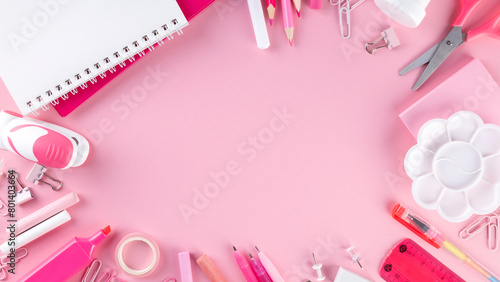Various school office and painting supplies on pink background. Back to school concept. Monochrome composition. Top view. Copy space