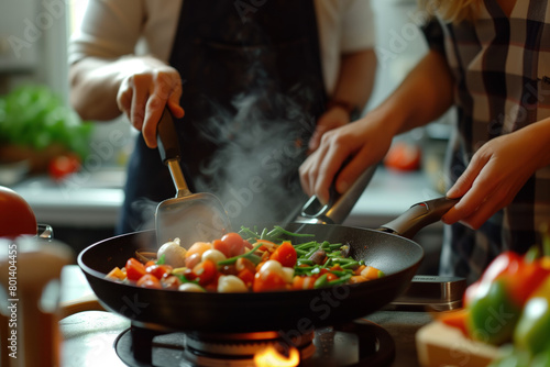Couple Cooking Together in a Kitchen Frying Vegetables on a Stove
