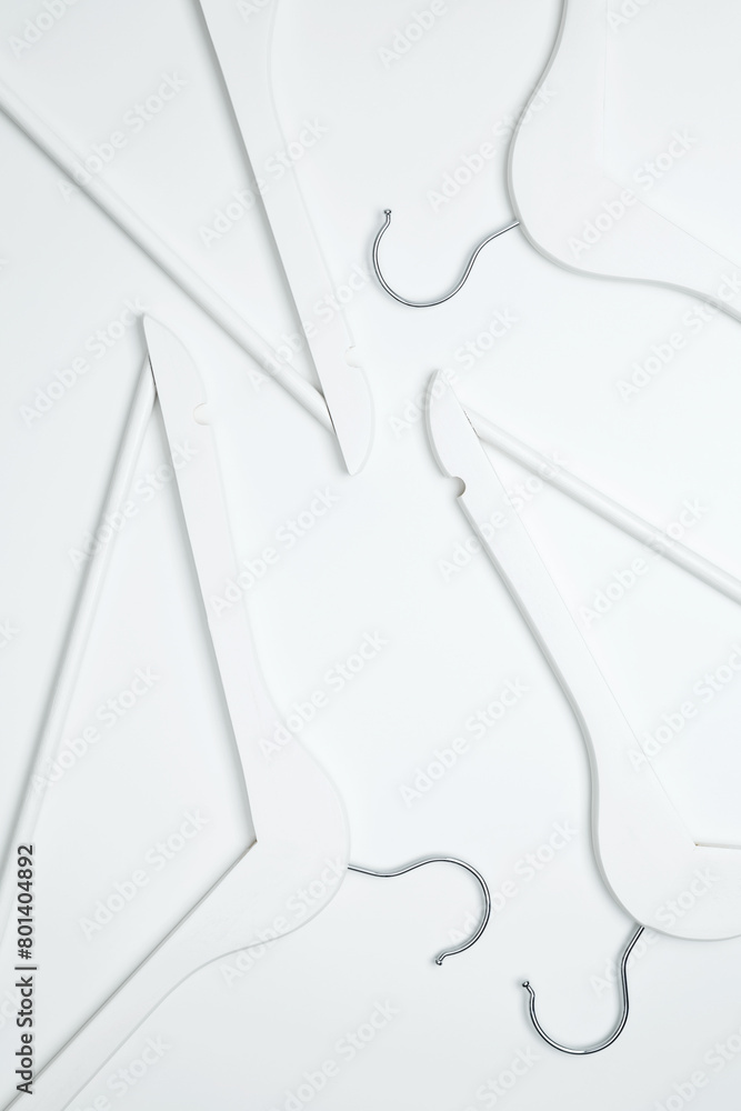 Obraz premium Creative flat lay hangers white background. Sale discount store promo shopping concept. Top view. Copy space