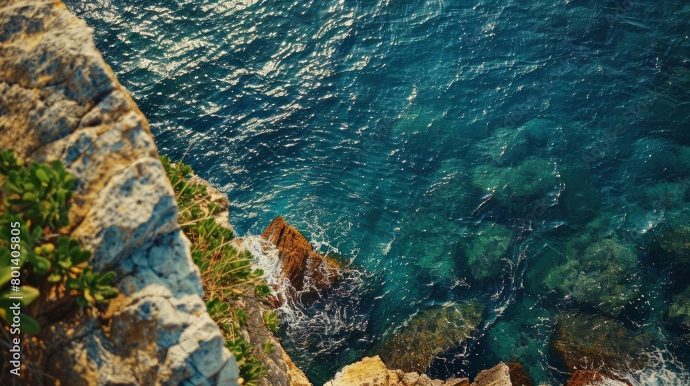 A view of the vast ocean stretching out to the horizon, seen from a rugged cliff edge. Waves crashing against the rocks below, with seagulls flying overhead.