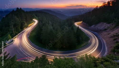 twilight traffic trails on winding forest road