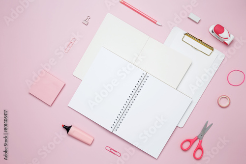 Creative flat lay mockup design of workspace. Top view composition with white notebook, to do list and stationery on pink background