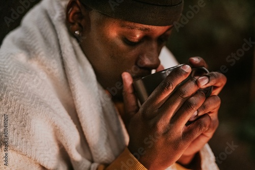 Canvas Print Man keeping warm with hot chocolate, a beanie, and a shawl