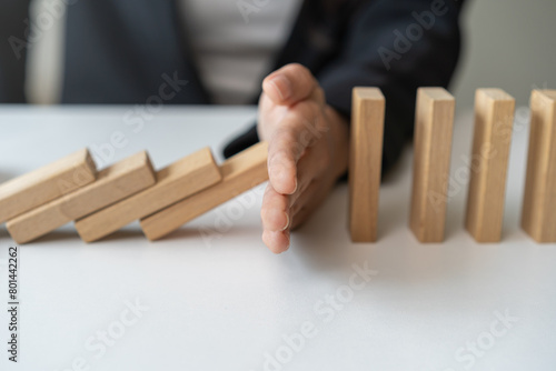 Fotografie Protection finance, stopping falling block effect collapse domino wooden, Recovery risk business, Management strategy and planning before destroy