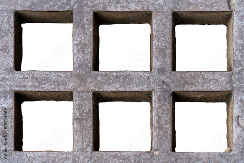 Cement grate with six square-shaped holes on a white background. photo