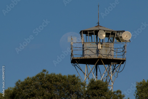 Принти на полотні full moon behind abandoned watchtower