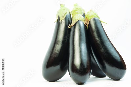 ripe dark eggplants on a white background. autumn eggplants on a light texture	