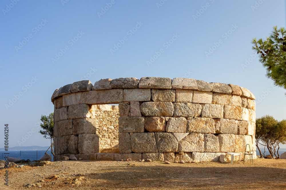 Ancient circular burial monument of 4th c. BC, of 3.5 meters high and 10.7m diameter, in Salamis island, Greece, Europe. Ancient circular burial monument of 4th c. BC, of 3.5 meters high and 10.7m diameter, in Salamis island, Greece, Europe.