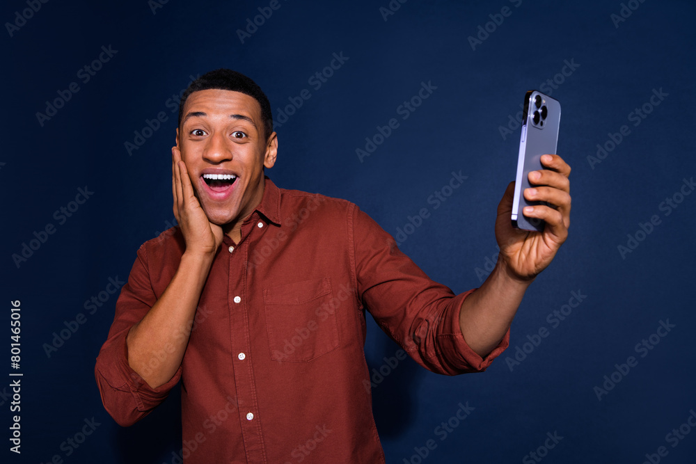 Photo of attractive funny guy wear formal shirt tacking selfie modern gadget emtpy space isolated blue color background Photo of attractive funny guy wear formal shirt tacking selfie modern gadget emtpy space isolated blue color background