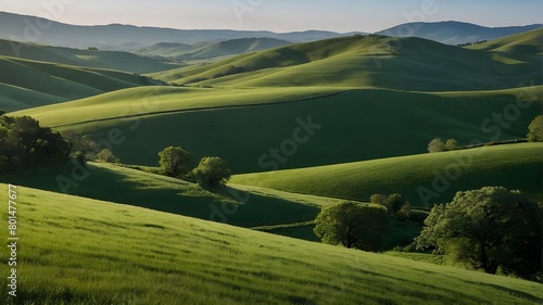 A view of rolling green hills separated against a clear backdrop.