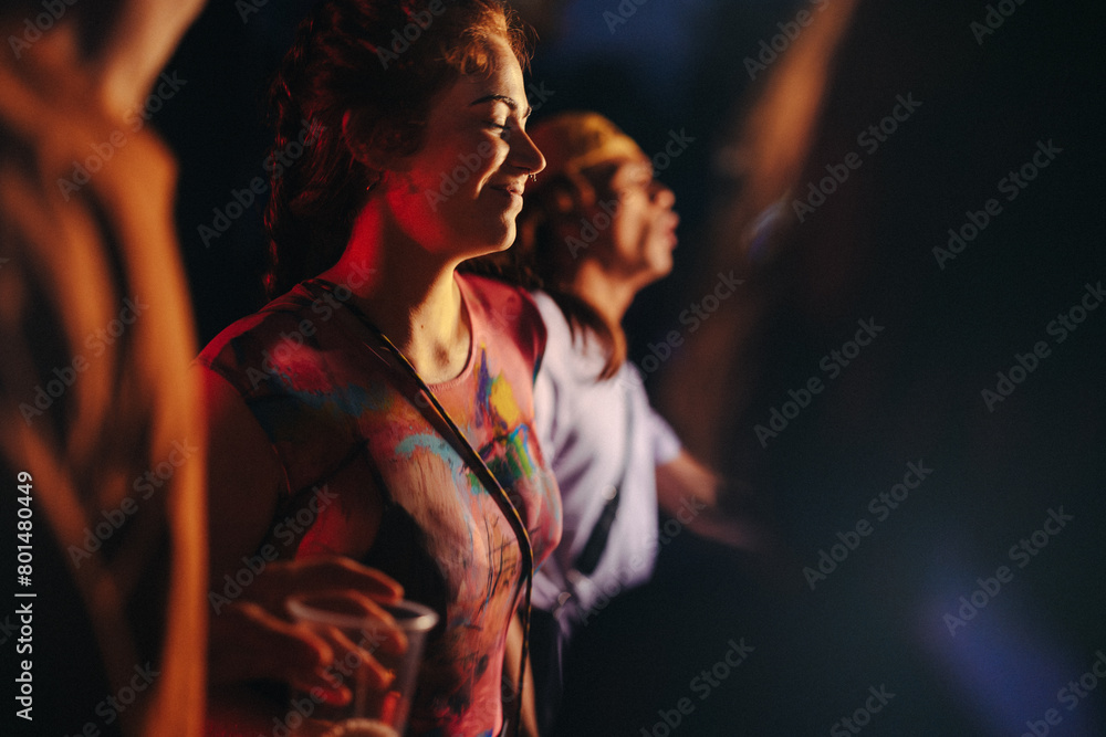 © Jacob Lund - Woman dancing and enjoying herself at a lively music festival