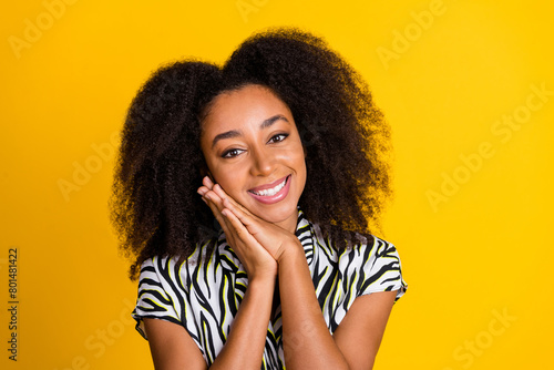 Portrait photo of young sweetie girlfriend in zebra glamour print shirt with beautiful curly hair isolated on yellow color background photo