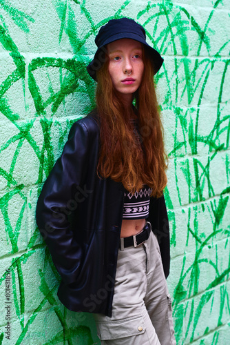 Beautiful young woman, natural red hair with black leather jacket