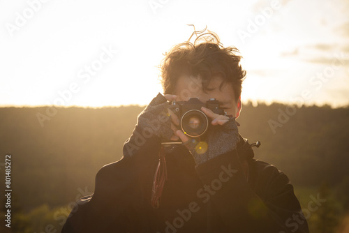 Young man with retro camera