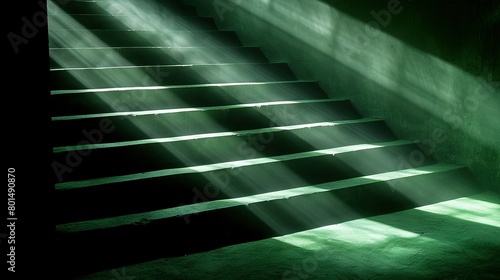  A staircase in a dimly lit chamber with a radiant source emanating from above a single step