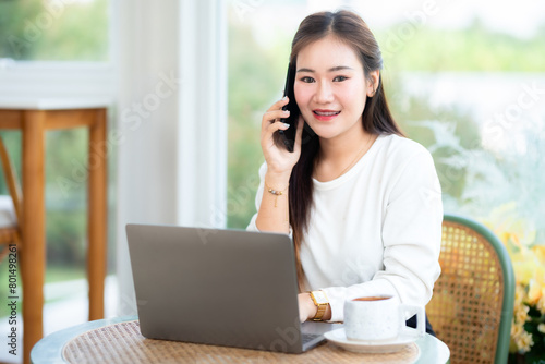 Happy of asian freelance people business female talking making using smartphone casual working with laptop computer and coffee cup in at the cafe, Business Lifestyle communication concept