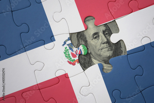 puzzle with the national flag of dominican republic and usa dollar banknote. finance concept