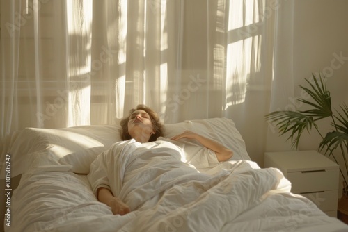 Serene Woman Enjoying Morning Sunlight in Comfortable White Bedroom