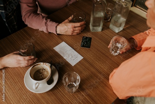 Slika na platnu Friends splitting the bill, credit card on the  table