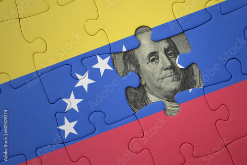 puzzle with the national flag of venezuela and usa dollar banknote. finance concept photo