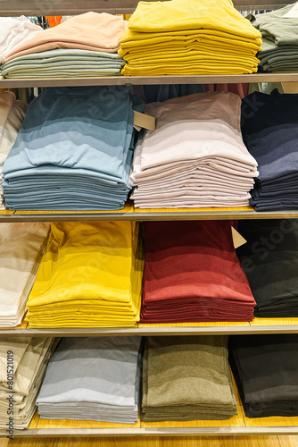 Rack of shirts with a variety of colors and styles. The shirts are neatly stacked and organized, creating a visually appealing display
