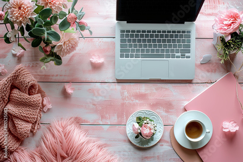 Flat lay laptop is on a table with a cup of coffee and a plate of flowers. Concept of relaxation and comfort © Sunshine