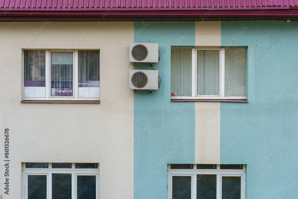 Outdoor air conditioning unit. A large modern air conditioner on the wall of an apartment building. Repair and maintenance of the air conditioning system Outdoor air conditioning unit. A large modern air conditioner on the wall of an apartment building. Repair and maintenance of the air conditioning system