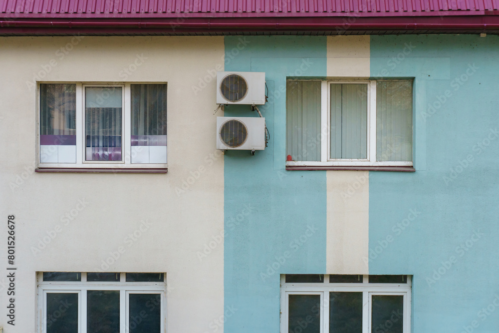 Outdoor air conditioning unit. A large modern air conditioner on the wall of an apartment building. Repair and maintenance of the air conditioning system