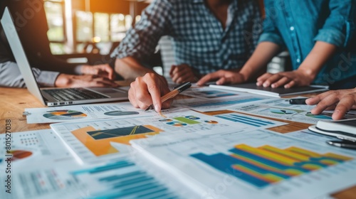 Close up of group of professional business people hands looking at financial plan. Top view of marketing team and project manager discussing and brainstorming idea while planning by paper. AIG42.