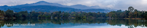 Ang Kaew lake with Doi Suthep mountains background in cloudy sky, Chiang mai , Thailand