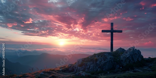 a cross on a hill with a sunset in the background and clouds in the sky above it