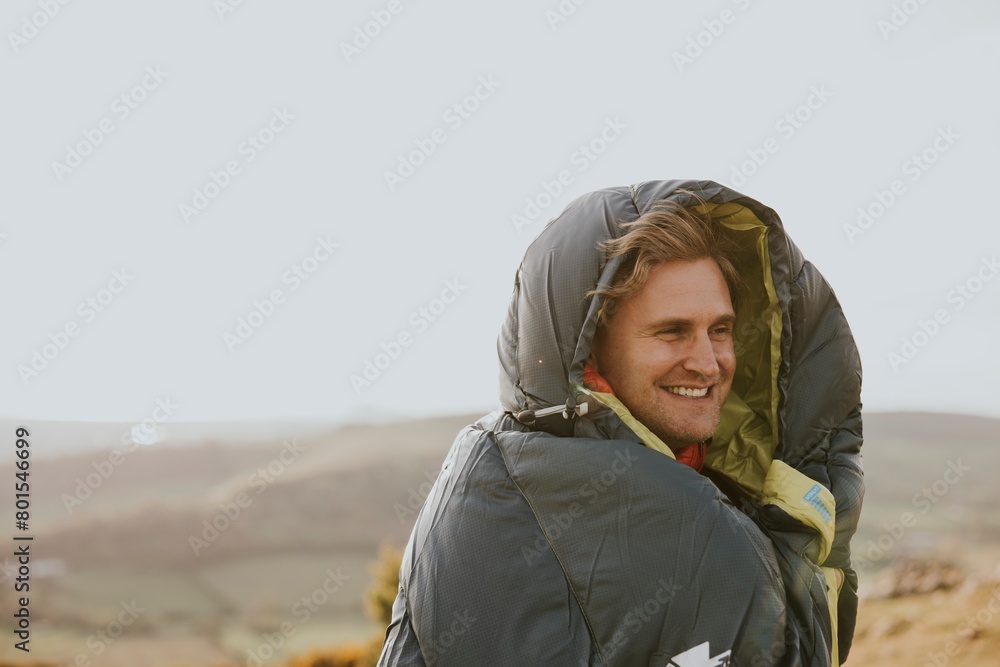 Smiling man in sleeping bag jacket, apparel photo Smiling man in sleeping bag jacket, apparel photo