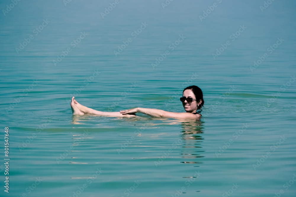 Woman relaxing in the mineral-rich waters of the Dead Sea, a popular wellness destination in Israel.