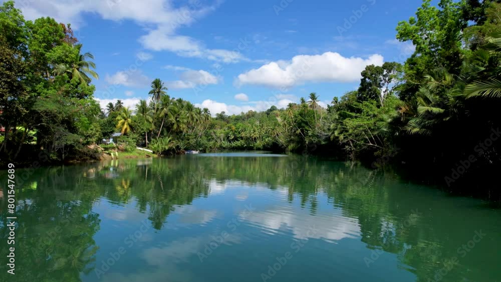 4K Aerial drone video of emerald Loboc river with riverside road and houses and sheds in Bohol, Philippines 4K Aerial drone video of emerald Loboc river with riverside road and houses and sheds in Bohol, Philippines