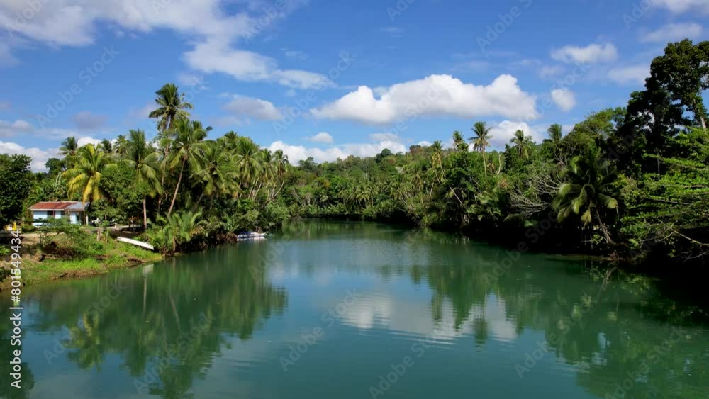 4K Aerial drone video of emerald Loboc river with riverside road and houses and sheds in Bohol, Philippines 4K Aerial drone video of emerald Loboc river with riverside road and houses and sheds in Bohol, Philippines