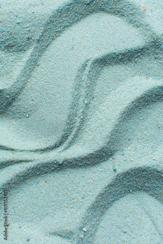 textured blue sand background, beautiful sand texture, overhead view of blue sand, zen pattern drawn in the sand, Top view of fine grain texture