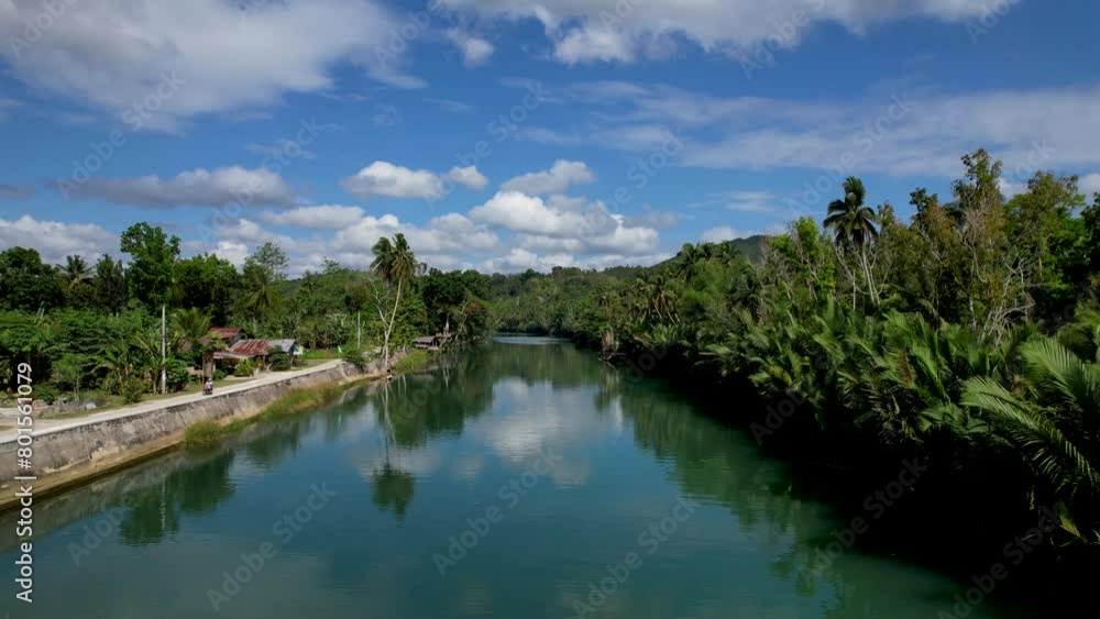 4K Aerial drone video of emerald Loboc river with riverside road and houses and sheds in Bohol, Philippines 4K Aerial drone video of emerald Loboc river with riverside road and houses and sheds in Bohol, Philippines