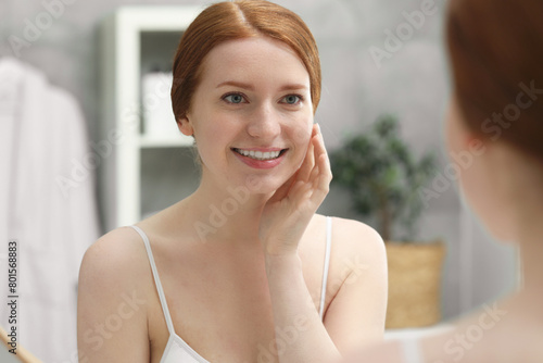 Free Download Smiling woman with freckles near mirror in bathroom - GFXLoad