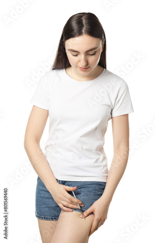 Diabetes. Woman making insulin injection into her leg on white background