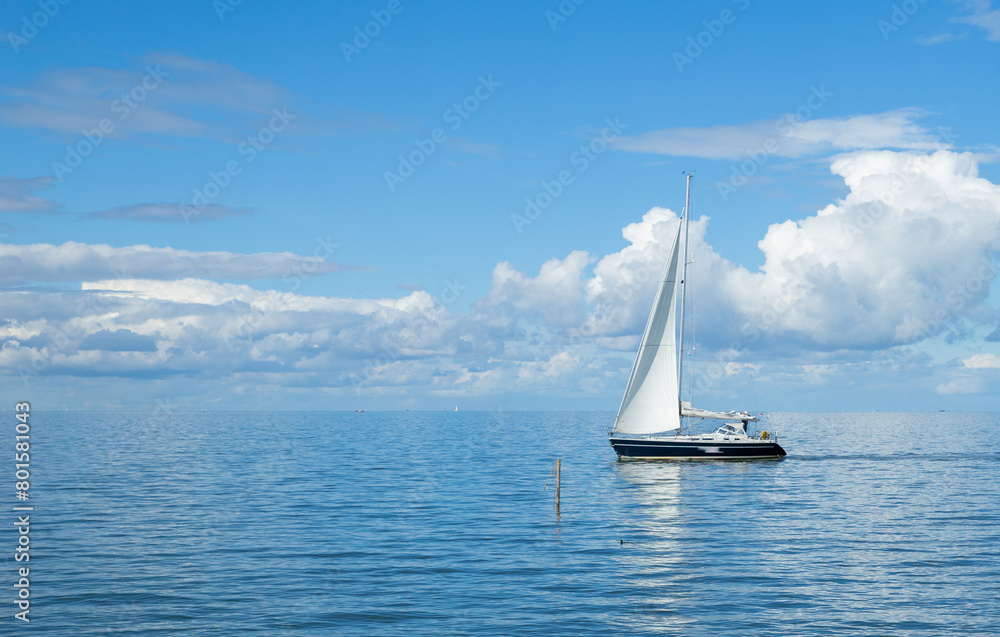 A sailboat on calm seas, 