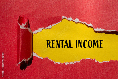 Rental income words written on ripped red paper with yellow background. Conceptual rental income symbol. Copy space. photo