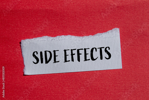 Side effects words written on ripped white paper with red background. Conceptual side effects symbol. Copy space.