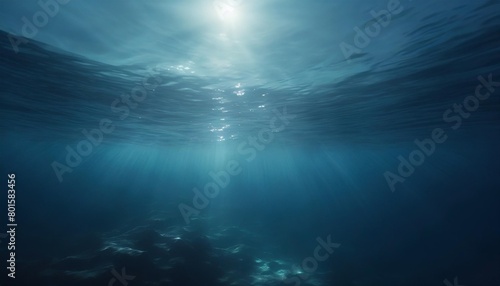 dark blue water of a deep sea with sun glare in the sky peaceful underwater landscape photo