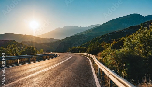 road in mountains kalabaka region meteora greece empty asphalt road with glowing perfect sky and sunlight landscape with beautiful winding mountain road with a perfect asphalt in the evening photo