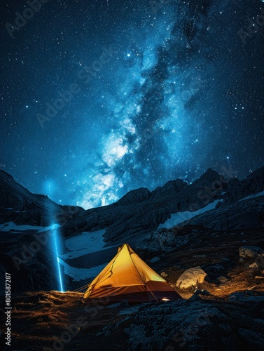 A yellow tent is set up in the middle of a snowy mountain. The sky is dark and starry, and the moon is visible in the distance
