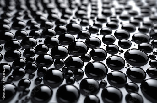 Abstract composition - shiny drops of black oil on a white background